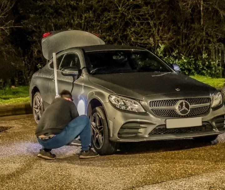 Mechanics working on a tyre