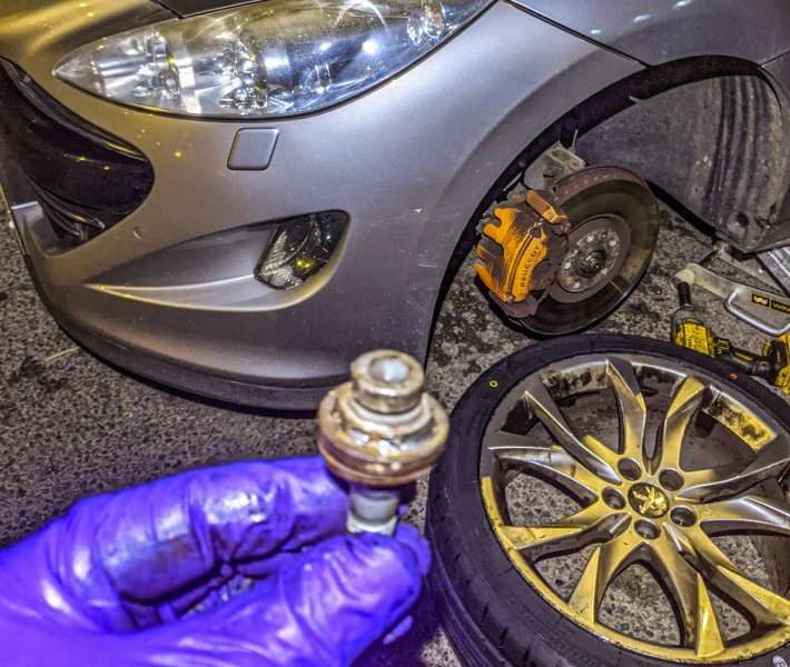 Mechanics working on a tyre