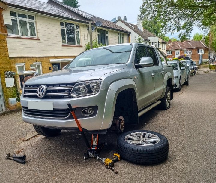 Mechanics working on a tyre