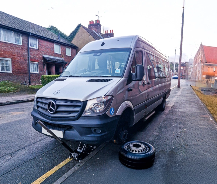 Mechanics working on a tyre