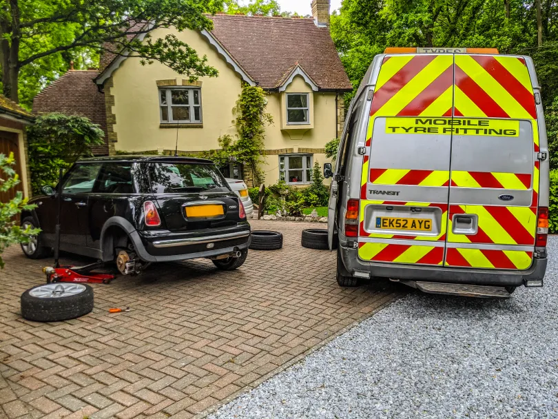 Mechanics working on a tyre