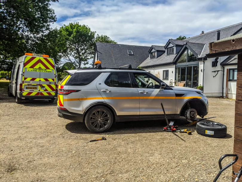 Mechanics working on a tyre